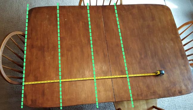 Measuring the distance from one edge of a table. Apologies to my metric-speaking readers, but the old-fashioned foot is the most convenient unit to demonstrate the virtual grid on a tabletop.